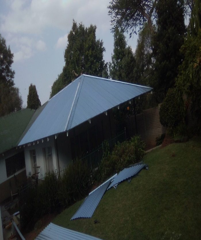Completed sheet roofing installation on a residential property